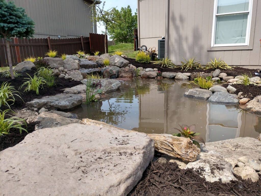 Professional landscapers at work in a beautiful garden